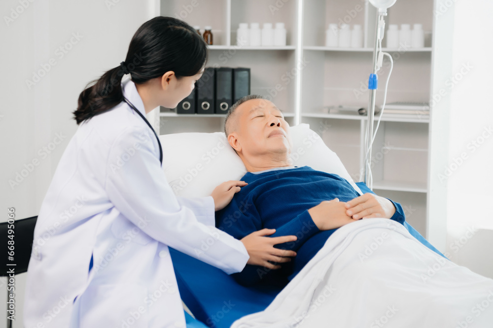 Doctor discussing treatment with Senior male patient talking and laughing sitting on examination bed in clinic or hospital Doctor discussing treatment with Senior male patient talking and laughing sitting on examination bed in clinic or hospital