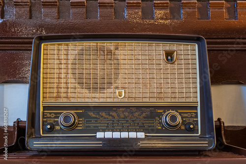 Antique radio on vintage background, Photo of a brown vintage radio with wooden casing.