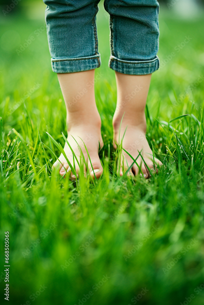 Child feet on the grass. Generative AI,