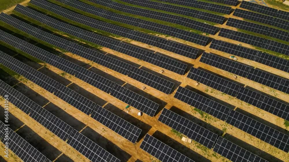 Ascending drone shot of solar panels and wind turbines in a vast grassy field in Taurage, Lithuania Ascending drone shot of solar panels and wind turbines in a vast grassy field in Taurage, Lithuania