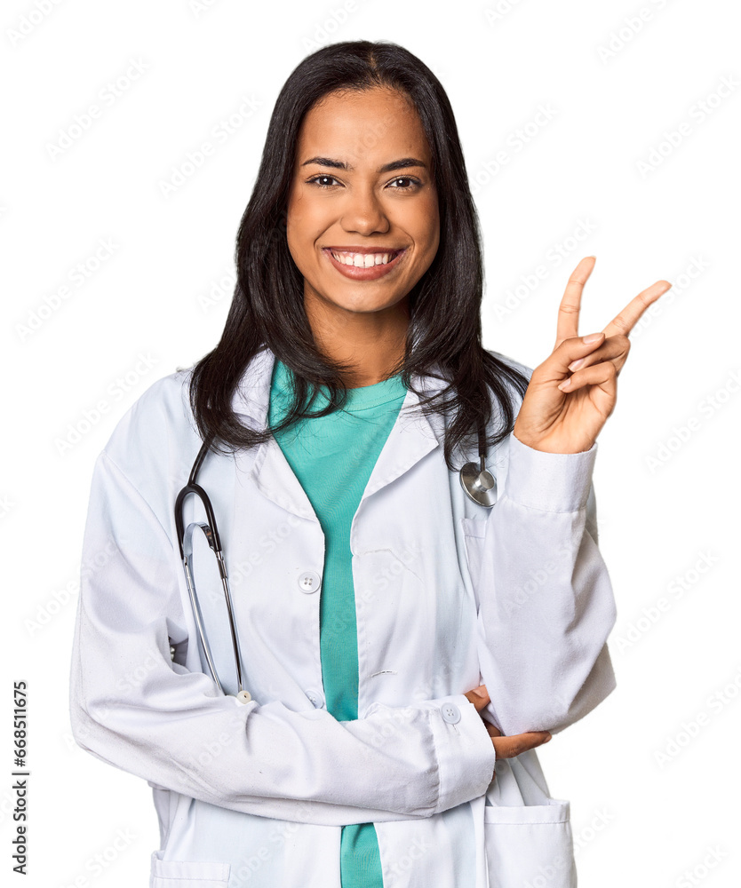Young Filipina doctor with stethoscope in studio showing number two with fingers. Young Filipina doctor with stethoscope in studio showing number two with fingers.