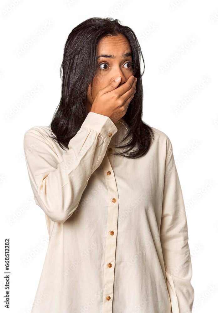 Young Filipina with long black hair in studio thoughtful looking to a copy space covering mouth with hand. Young Filipina with long black hair in studio thoughtful looking to a copy space covering mouth with hand.
