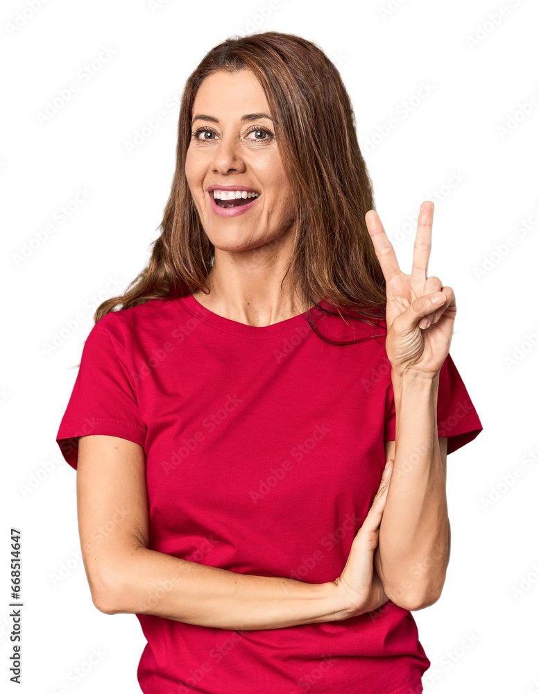 Middle-aged woman portrait in studio setting showing number two with fingers. Middle-aged woman portrait in studio setting showing number two with fingers.
