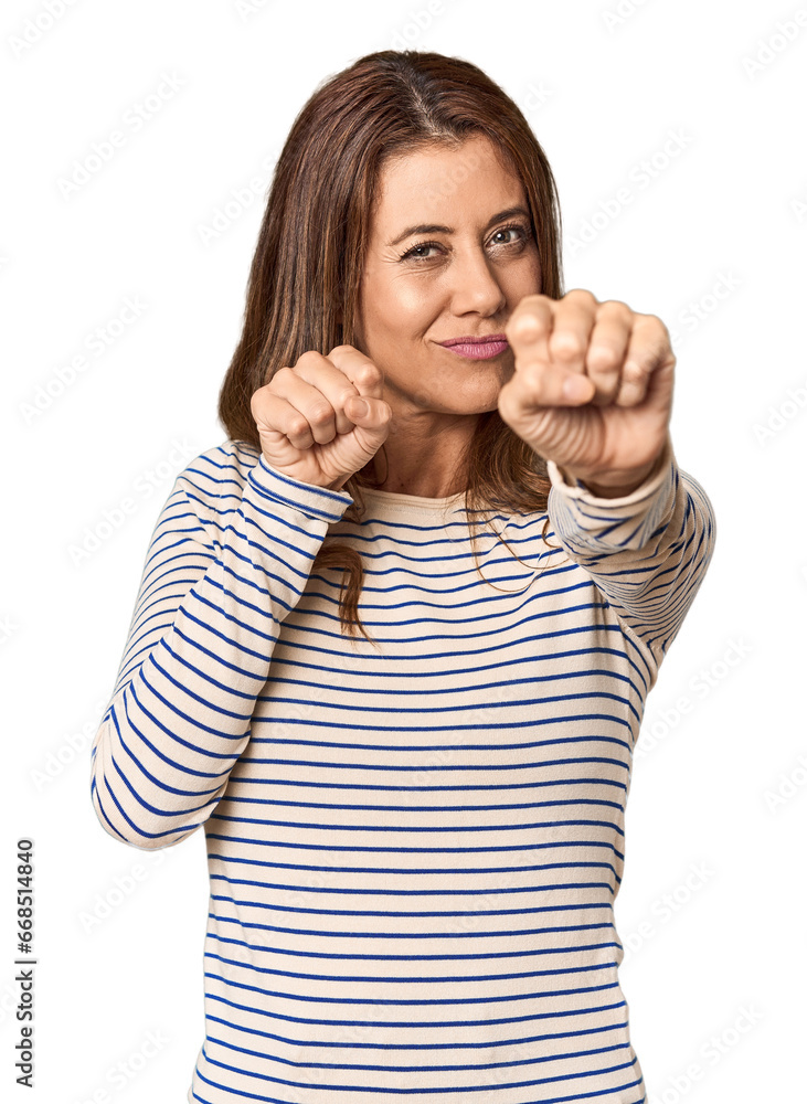 Middle-aged woman portrait in studio setting throwing a punch, anger, fighting due to an argument, boxing. Middle-aged woman portrait in studio setting throwing a punch, anger, fighting due to an argument, boxing.