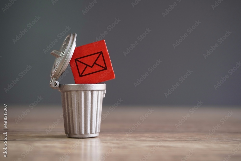 Closeup image of wooden cube with mail icon inside trash can. Junk mail and spam mail concept. - obrazy, fototapety, plakaty 