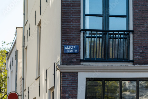 Fotografija Amstel centrum in Amsterdam. Sign on the wall with a balcony
