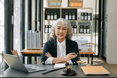 фотографія Senior asian woman lawyer working and gavel, tablet, laptop in front, Advice justice and law concept
