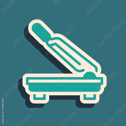 Green Paper cutter icon isolated on green background. Long shadow style. Vector