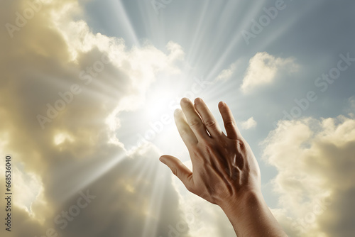 Reaching for Hope: Human Hand Touching the Divine Light Amongst the Clouds, Symbol of Faith and Aspiration