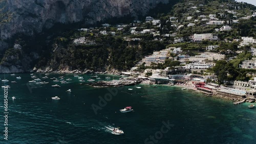 Aerial view of Italy's resorts lining Capri's shoreline. photo