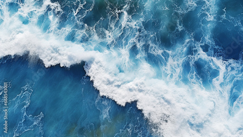 Stunning aerial view of waves crashing on the shore.