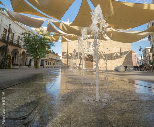 Water stream splashing and coming out of the ground in the main square of Villanueva de la Serena. photo