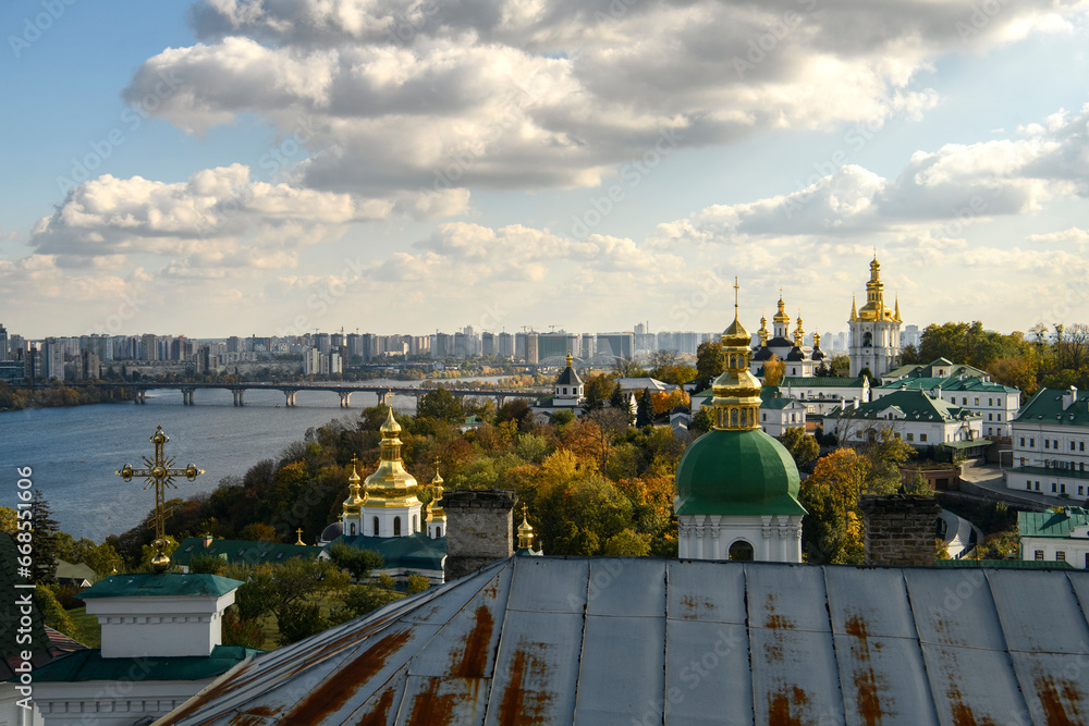 Panoramic view of Kyiv Pechersk Lavra churches, the Dnieper river and high buildings in Kyiv, Ukraine. October 23, 2023