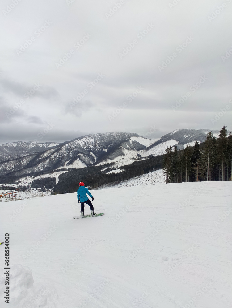 snowboarder at ski slope mountains landscape on background