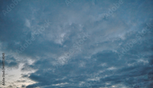 Summer evening sky in the picturesque clouds, lit by the rays of the setting sun.