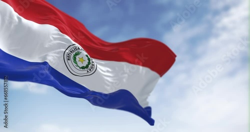 Slow motion loop of Paraguay flag waving against clear sky photo