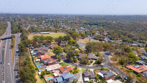 Aerial drone view of homes and streets above Bangor in the Sutherland Shire, south Sydney, NSW Australia showing Bangor Bypass in the background 