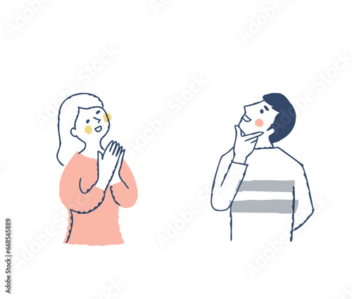 上の方を見ながら喜ぶ若いカップル