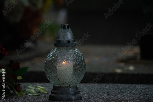 Warsaw, Poland - October 24, 2023: Graves in the cemetery on a cloudy, foggy day. Weather for All Saints' Day. Candles and flowers on graves.