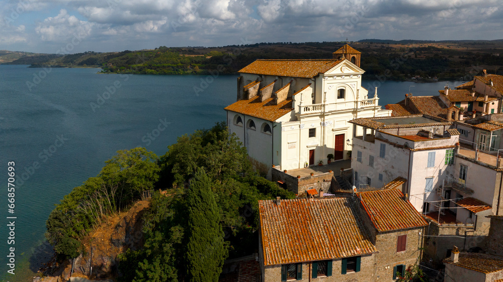 Aerial view of the collegiate church of Santa Maria Assunta in the historic center of Anguillara,in the metropolitan city of Rome, Italy. It's a Catholic church located on the shores of Lake Bracciano