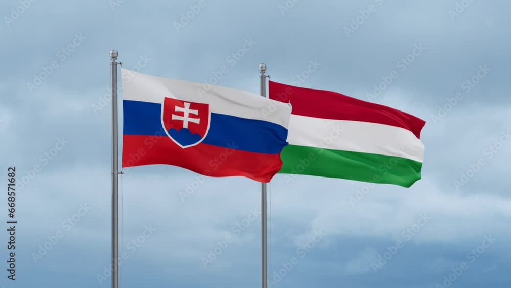 Hungary flag and Slovakia flag waving together on cloudy sky, endless seamless loop, two country relations concept Hungary flag and Slovakia flag waving together on cloudy sky, endless seamless loop, two country relations concept