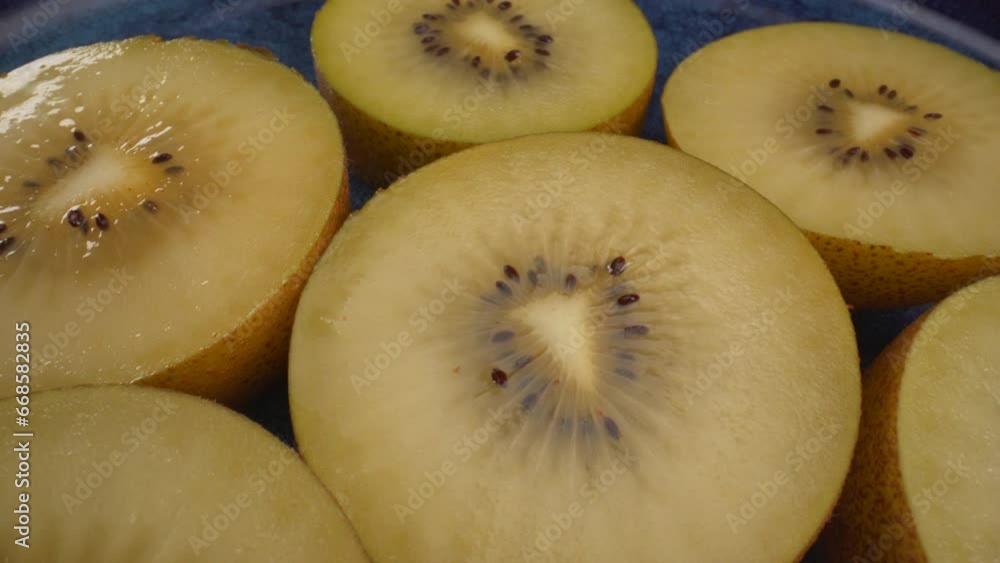 Amazing close up rotating yellow kiwi fruits on a plate, juicy tropical exotic fruit, 4K macro shot Amazing close up rotating yellow kiwi fruits on a plate, juicy tropical exotic fruit, 4K macro shot