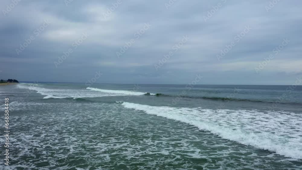 Moving over small waves on a tropical beach in Ecuador