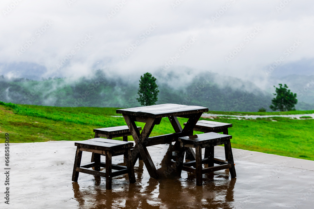 landscape of view rain season mist and wooden chair on the mountains in northern thailand beautiful green trees and fresh . landscape of view rain season mist and wooden chair on the mountains in northern thailand beautiful green trees and fresh .