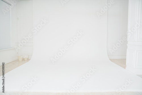 A photo studio with a white cyclorama for a professional photo shoot. 