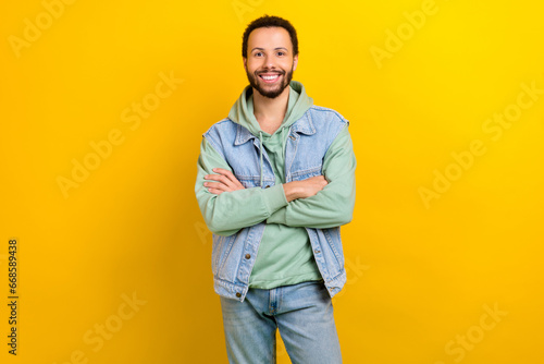 Portrait of cheerful satisfied young person toothy smile crossed arms posing isolated on yellow color background © deagreez