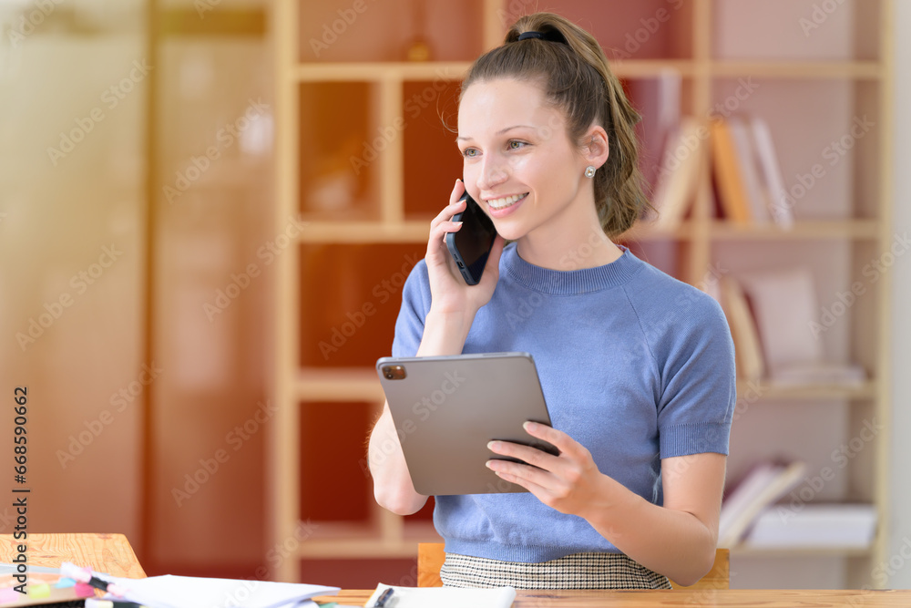 Businesswoman talking on the smartphone in the office Businesswoman talking on the smartphone in the office