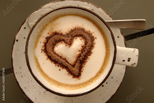 Capuccino with heart-shaped cocoa on café table in Sankt Gallen, Switzerland