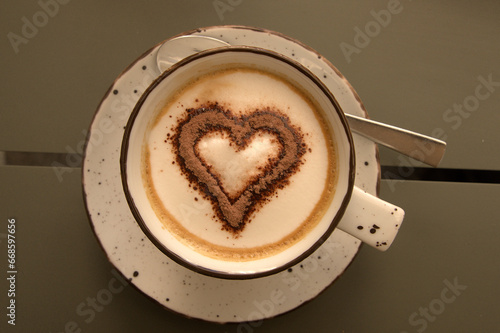 Capuccino with heart-shaped cocoa on café table in Sankt Gallen, Switzerland