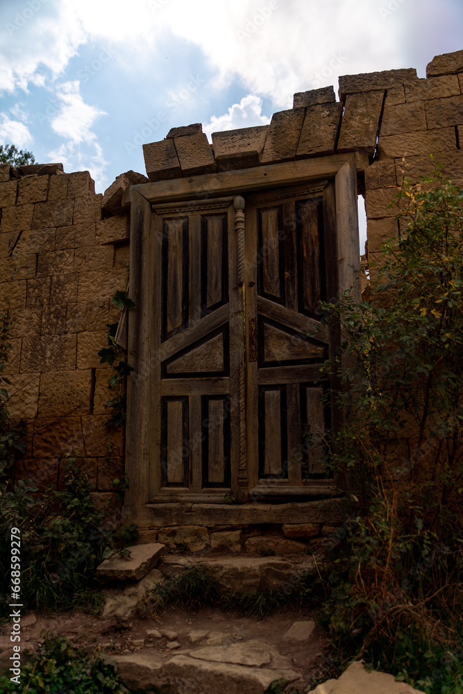 Dagestan Gamsutl. Ancient ghost town of Gamsutl old stone houses in abandoned Gamsutl mountain village in Dagestan, Abandoned etnic aul, summer landscape.