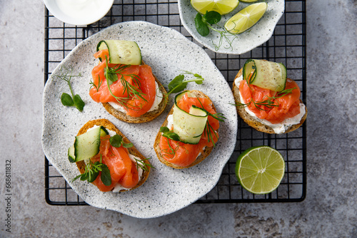 Homemade crostini with smoked salmon and cucumber photo