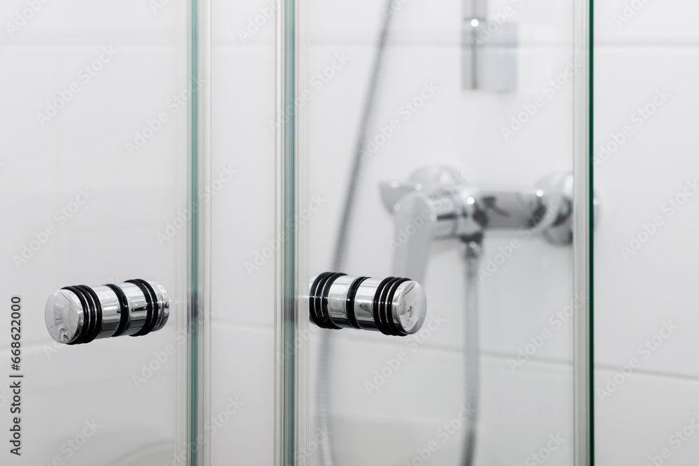 Shower Cabin Door Close up. Welcome to Bathroom. Modern White Tiled Wall in Shower. Shower Cabin Door Close up. Welcome to Bathroom. Modern White Tiled Wall in Shower.
