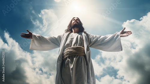 Jesus Christ with open arms against blue sky with white clouds and sun