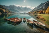A lot of wooden boats on the background of a clear lake and mountains covered with white snow in autumn in a natural park, resort. Travel, nature, recreation concepts