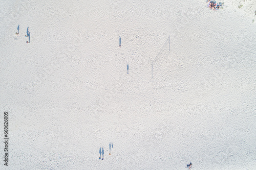 aerial zenithal view from drone of people playing beach volleyball
