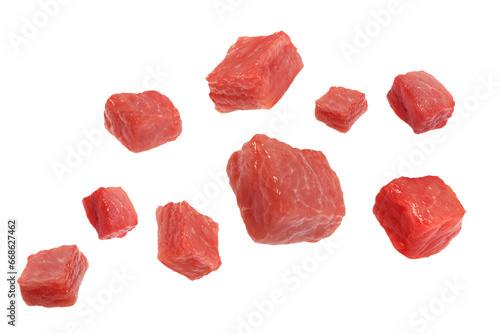 Pieces of raw beef for goulash flying on white background