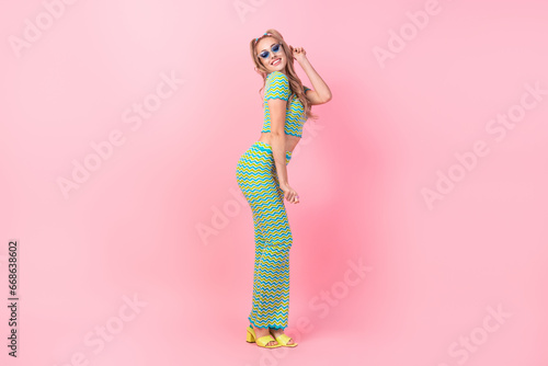 Full length photo of lovely young lady summer vacation posing defile wear trendy green print garment isolated on pink color background