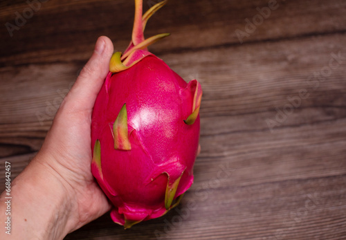 Dragon fruit. Tropical fruits. On a wooden background. Top view. Copy space.