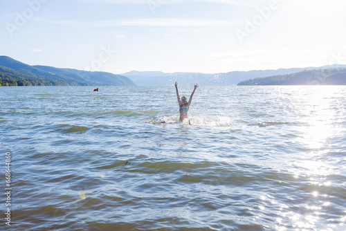 Summertime, child enjoying water fun on sunny summer vacation.