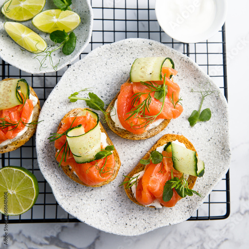 Homemade crostini with smoked salmon and cucumber photo