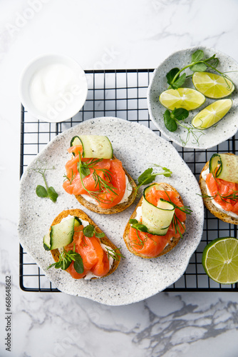 Homemade crostini with smoked salmon and cucumber photo