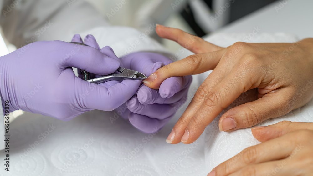 Cuticle removal by skilled professionals at serene beauty salon. Pampering nails with care