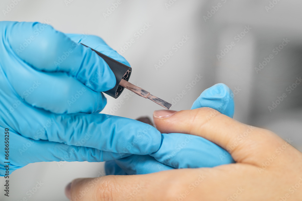Relaxing nail manicure experience at beauty salon. Nail manicure painting in beauty salon Relaxing nail manicure experience at beauty salon. Nail manicure painting in beauty salon