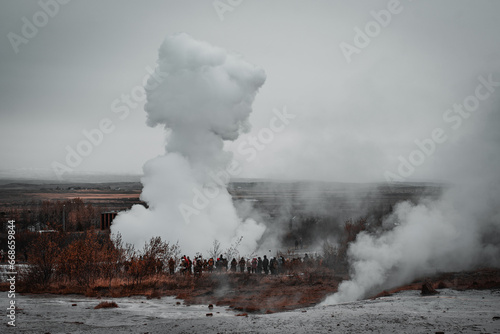 Silhouettes of people around the geyser Haukadalur Blesi of the Golden Circle, Iceland