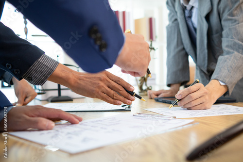 Businessmen and investors sign contract in front of company legal advisor and witness contract for their real estate investment. signing contract between businessman and an investor in front of lawyer