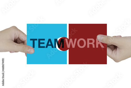 Teamwork letters jigsaw being connected by two hands of business man to make the word completed on white background.